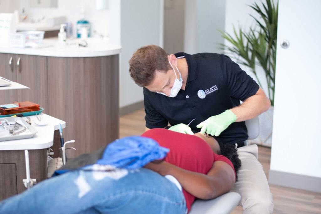 Orthodontic treatment in progress Orthodontist adjusting invisalign during an an appointment in chesapeake va at glass orthodontics
