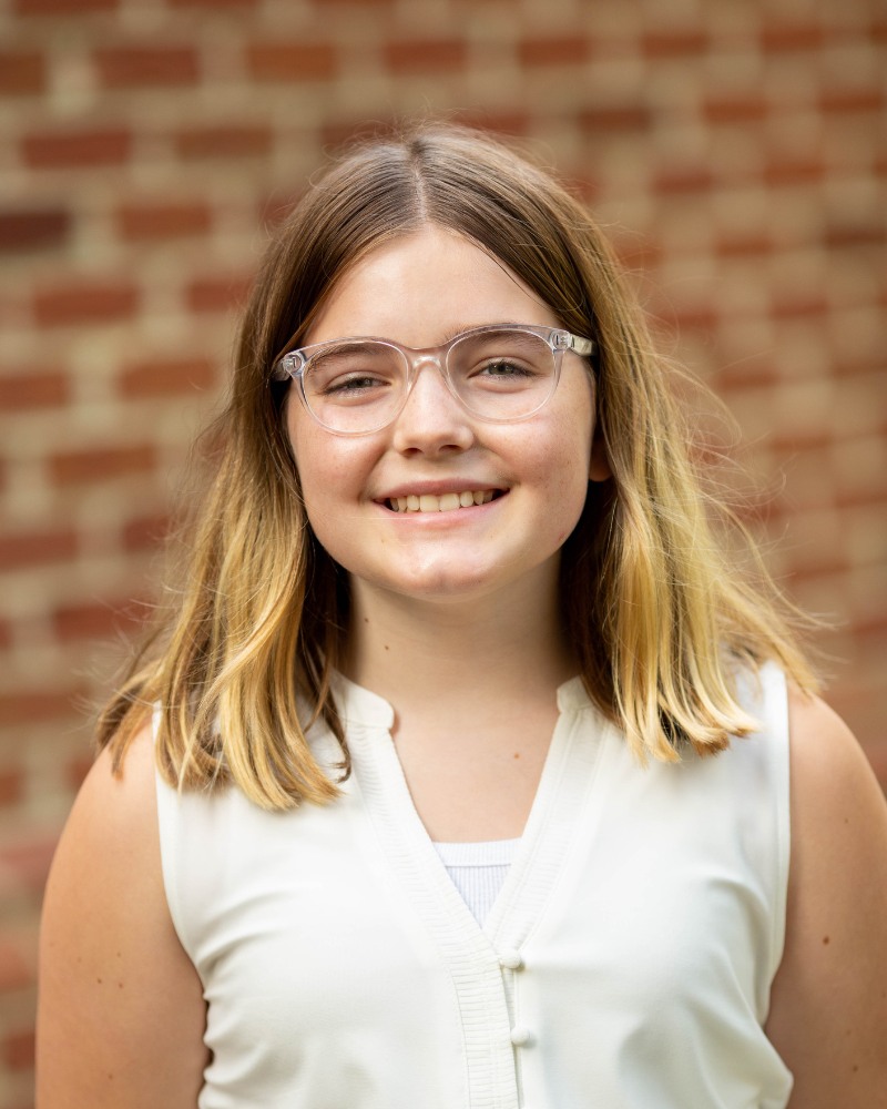 Teen orthodontic patient wearing glasses smiling with straight teeth Chesapeake VA