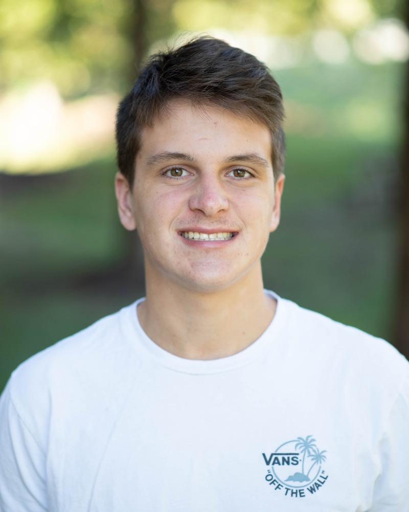 Teen orthodontic patient smiling with straight teeth outdoors Chesapeake VA