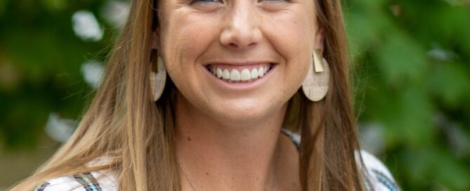 Teen orthodontic patient smiling outdoors with aligned teeth Chesapeake VA