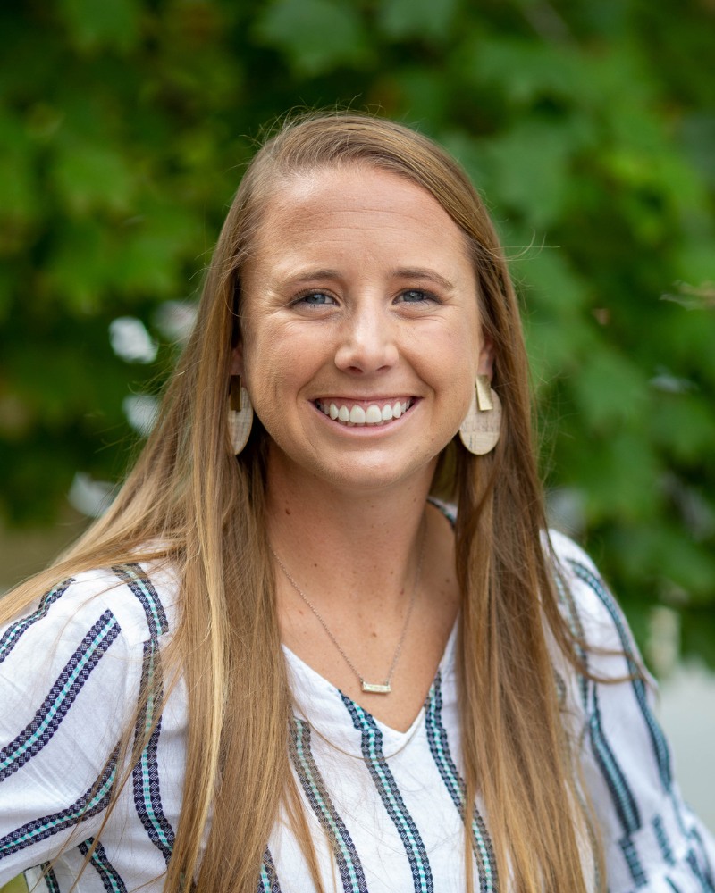 Teen orthodontic patient smiling outdoors with aligned teeth Chesapeake VA