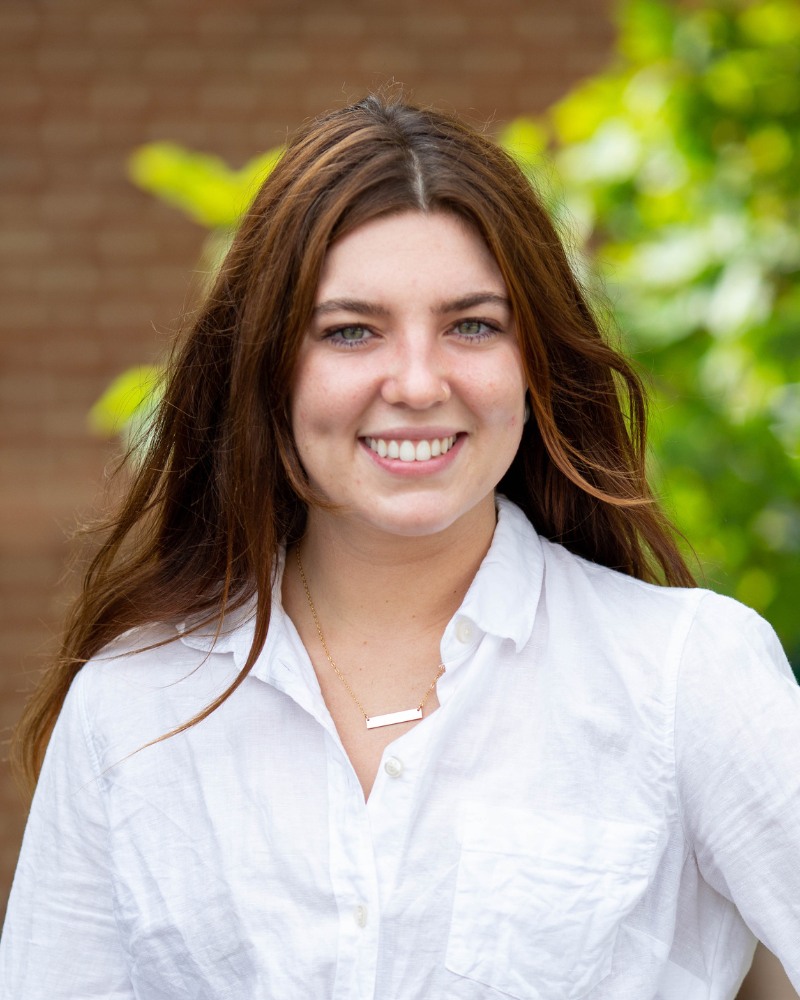 Teen patient smiling outdoors after orthodontic treatment Chesapeake VA