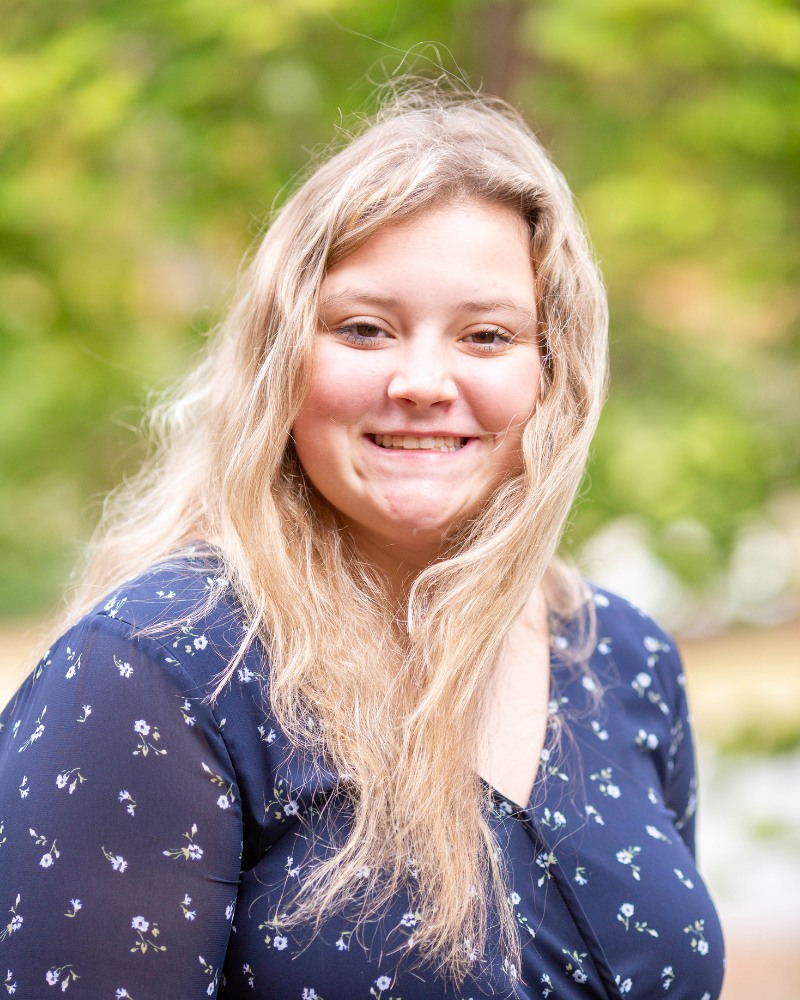Teen patient smiling outdoors after orthodontic treatment in Chesapeake Virginia